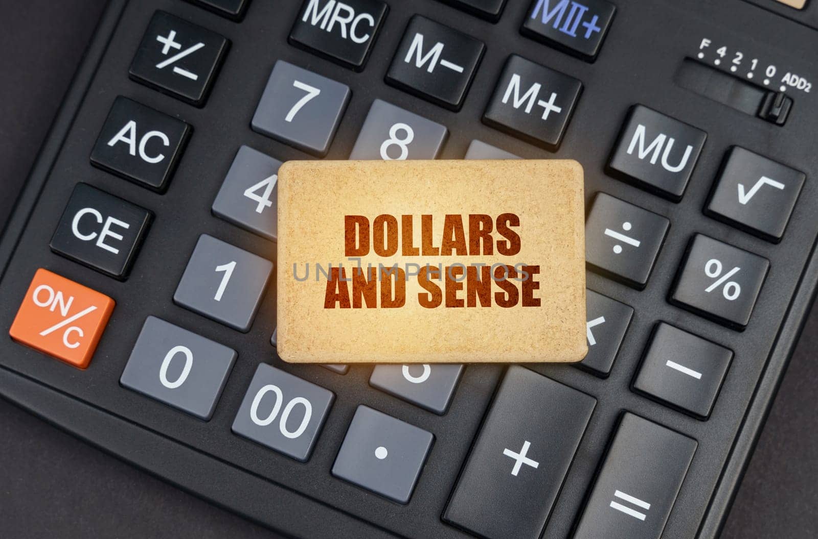 There is a sign on the calculator that says - Dollars and sense by Sd28DimoN_1976