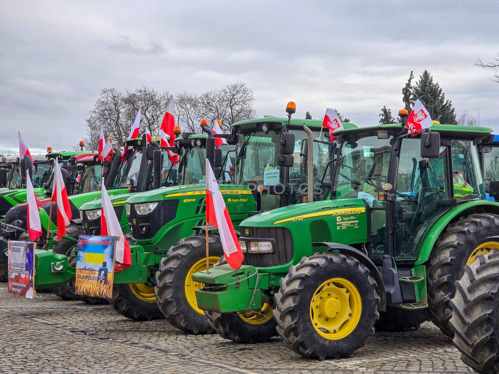 Wroclaw, Poland, February 15, 2024: Farmers protest against the European Union's anti-agricultural policies. Several farm tractors are parked under a cloudy sky