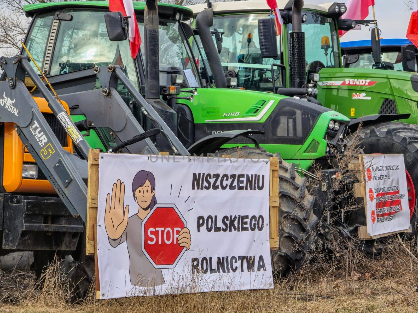Wroclaw, Poland, February 15, 2024: Protesting farmers with slogans on banners. Hundreds of agricultural tractors lined up in Wroclaw