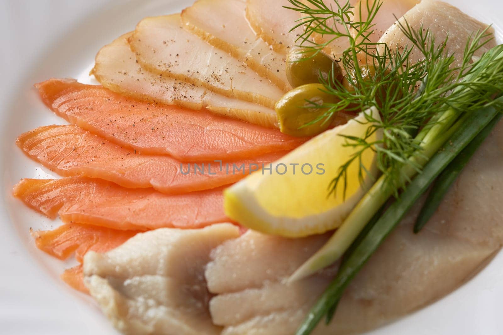 Image of delicious fish slicing with greenery, close-up