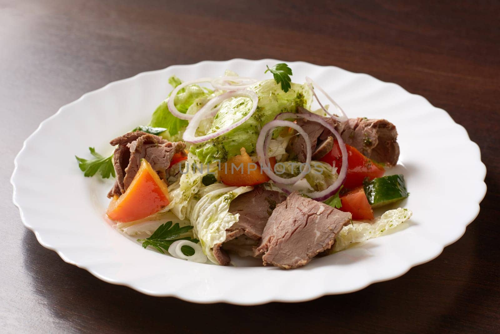 Delicious salad made of meat and vegetables, close-up