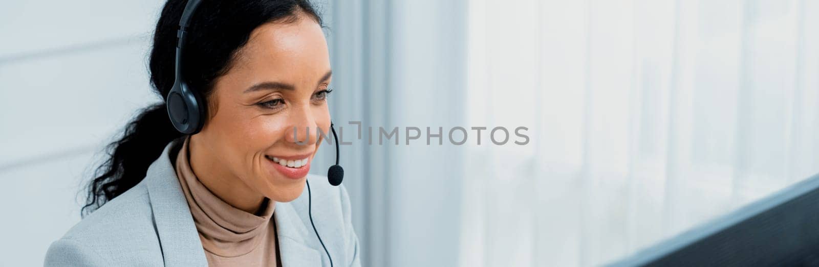 African American young businesswoman wearing headset working in crucial office by biancoblue