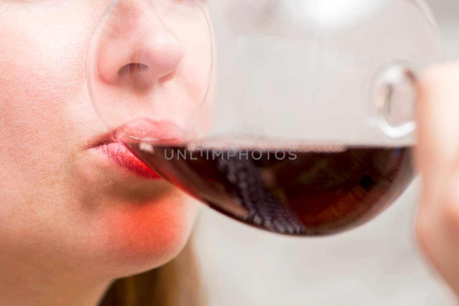 Close-Up of Woman Sipping Red Wine by andreyz