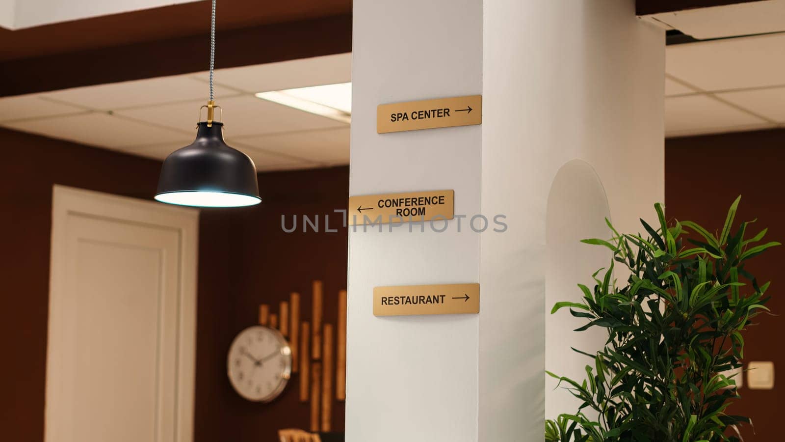 Empty stylish business accommodation lobby interior with deluxe spa center, conference room, and restaurant amenities. Close up of hotel facilities plaque signs on resort foyer wall