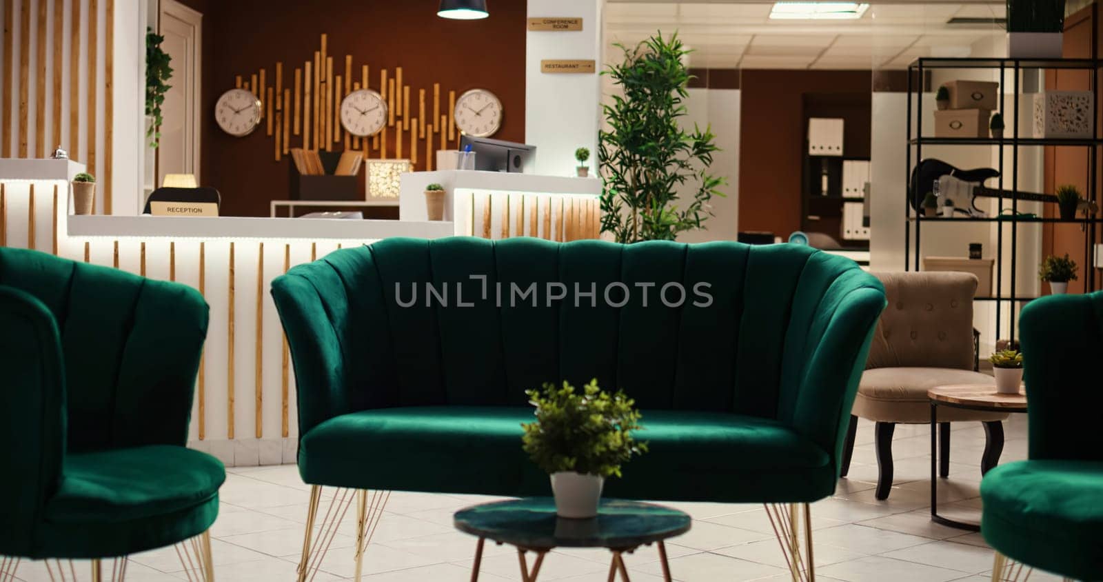 Crane down shot of welcoming rustic hospitality industry lobby interior filled with plants, waiting for guests. Empty cozy stylish hotel check in reception desk ready for arriving tourists