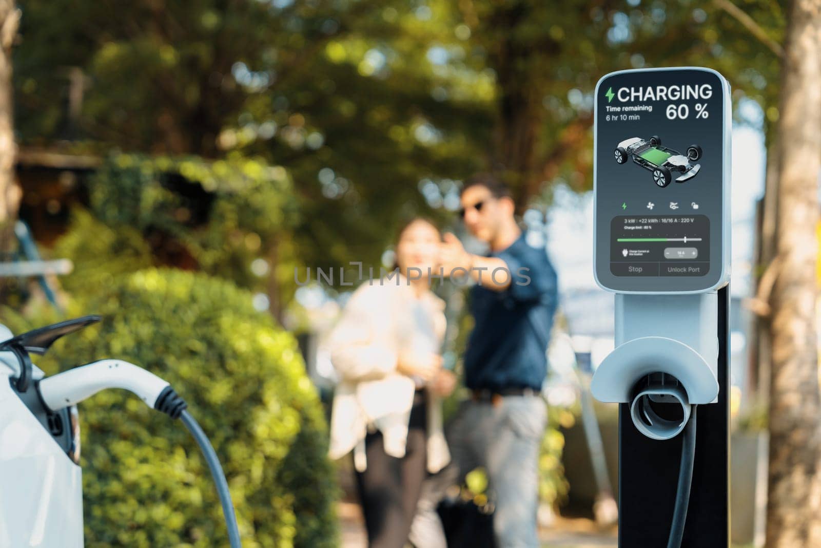 Young couple recharge electric car's battery from charging station. Expedient by biancoblue