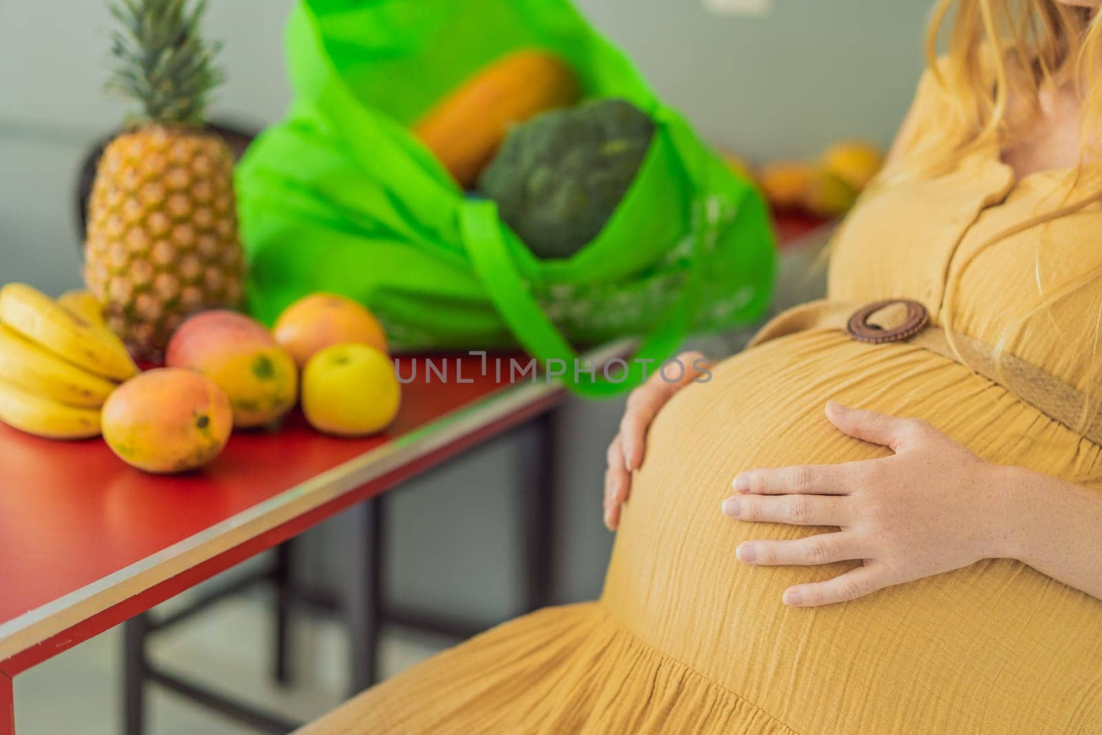 Exhausted but resilient, a pregnant woman feels fatigue after bringing home a sizable bag of groceries, showcasing her dedication to providing nourishing meals for herself and her baby by galitskaya