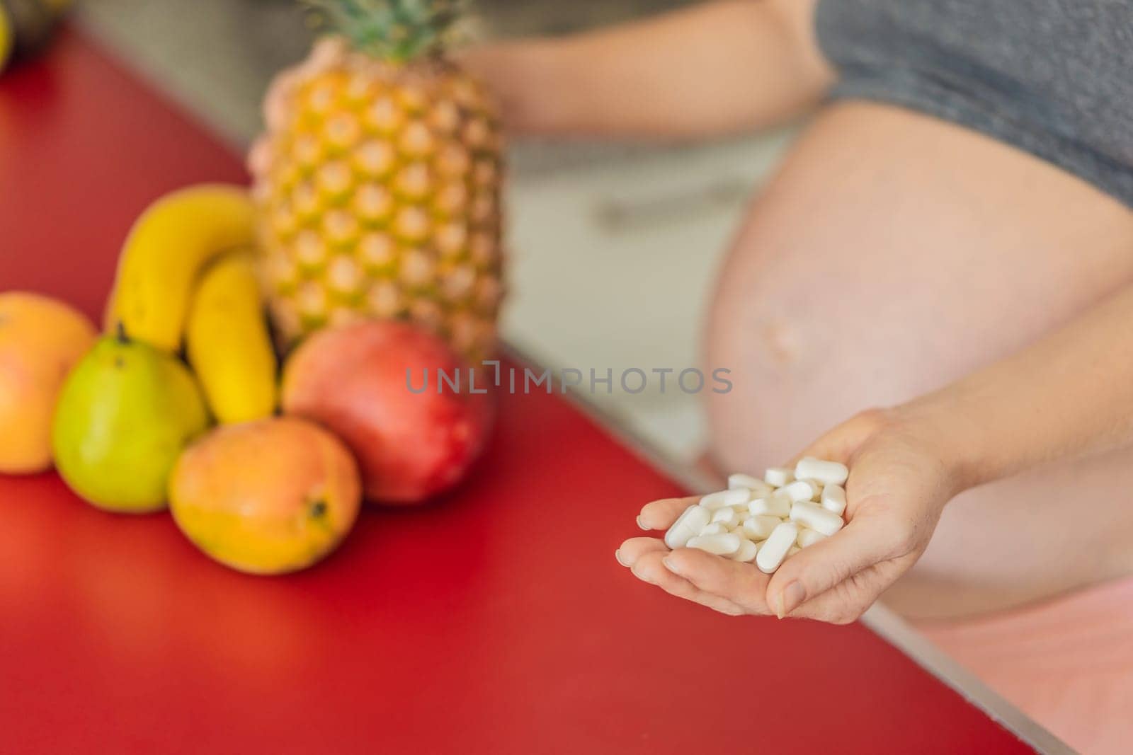 Balancing choices for optimal nutrition, a pregnant woman decides between the wholesome goodness of fresh fruits and the convenience of vitamin tablets, ensuring a well-rounded approach to her prenatal health.