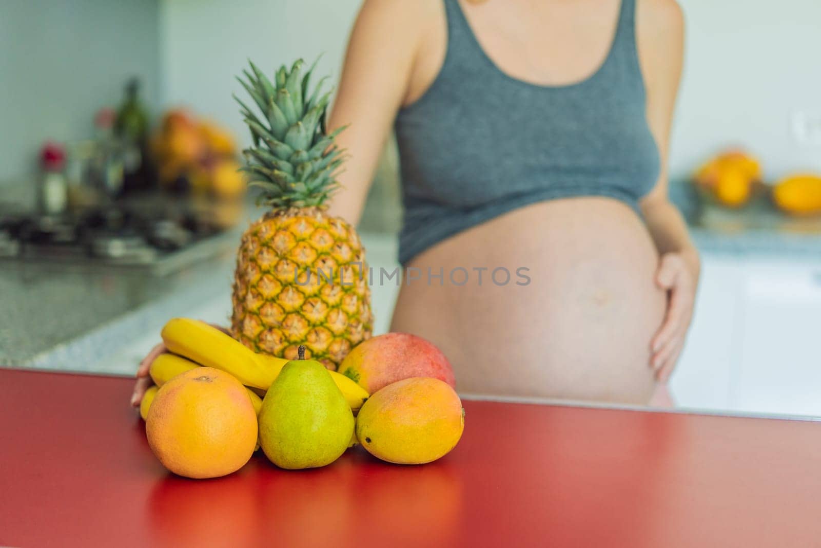 Embracing a healthy choice, a pregnant woman prepares to enjoy a nutritious moment, gearing up to eat fresh fruit and nourish herself during her pregnancy by galitskaya