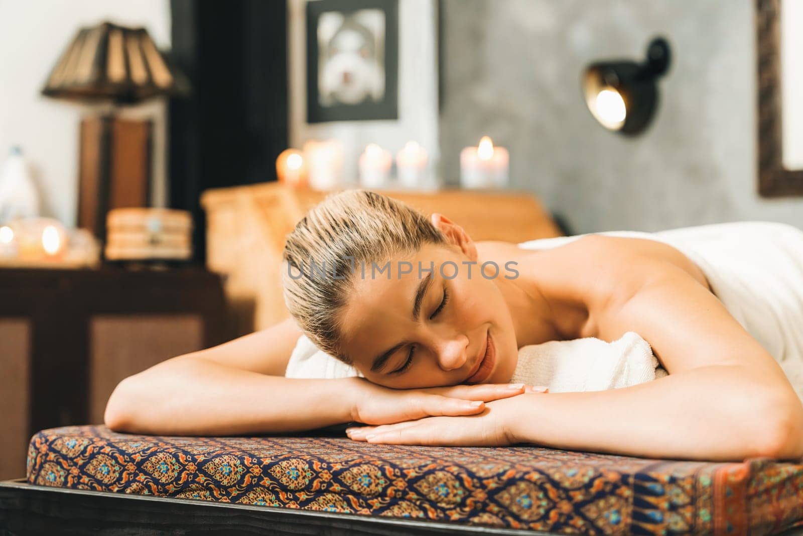 Beautiful caucasian woman lie on spa bed in front of sauna cabinet. Tranquility. by biancoblue
