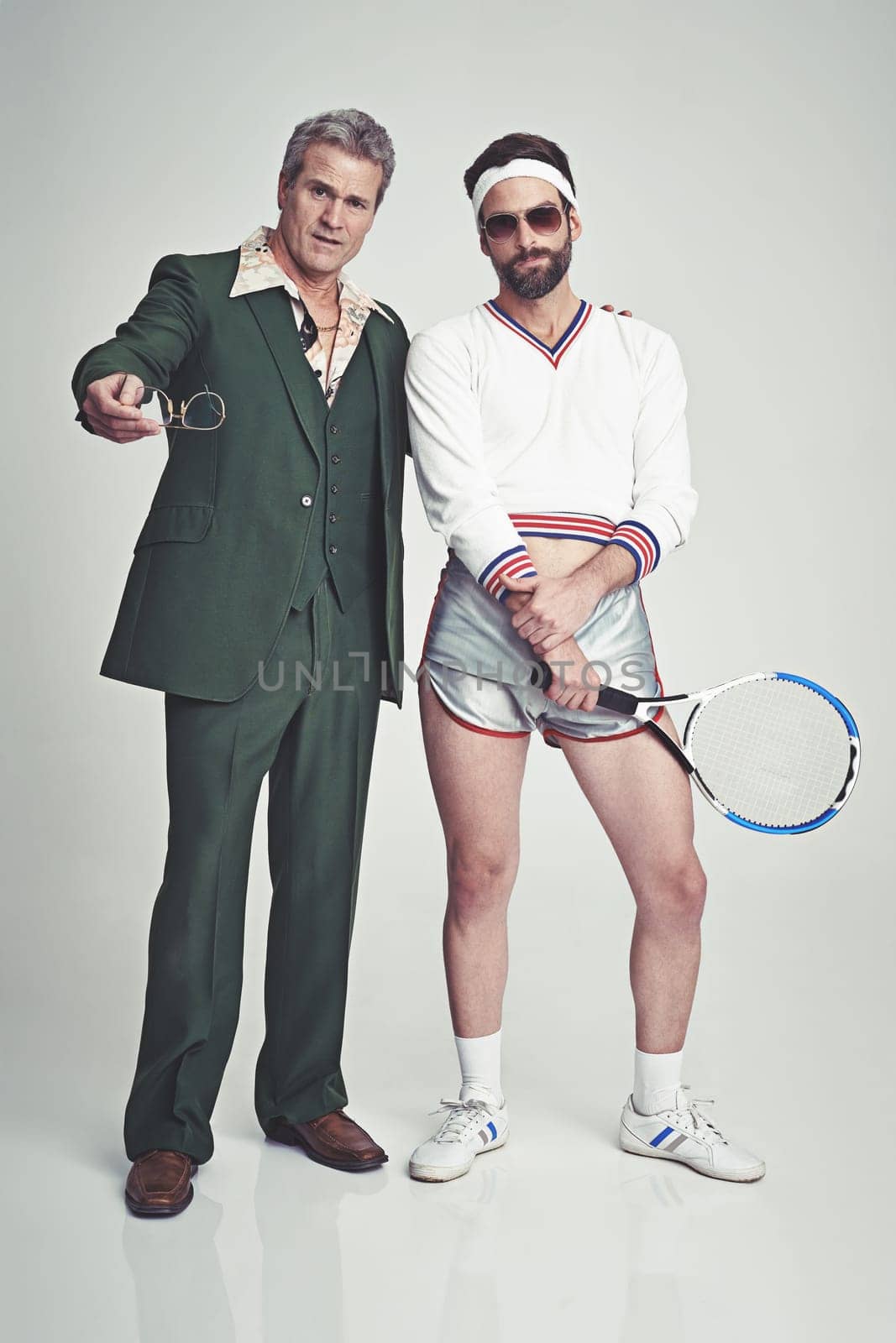 Men, retro and fashion with confidence in studio on white background and smart look with suit and tennis racket. Vintage style and glamour with trends for outfit, elegance and clothes with class.