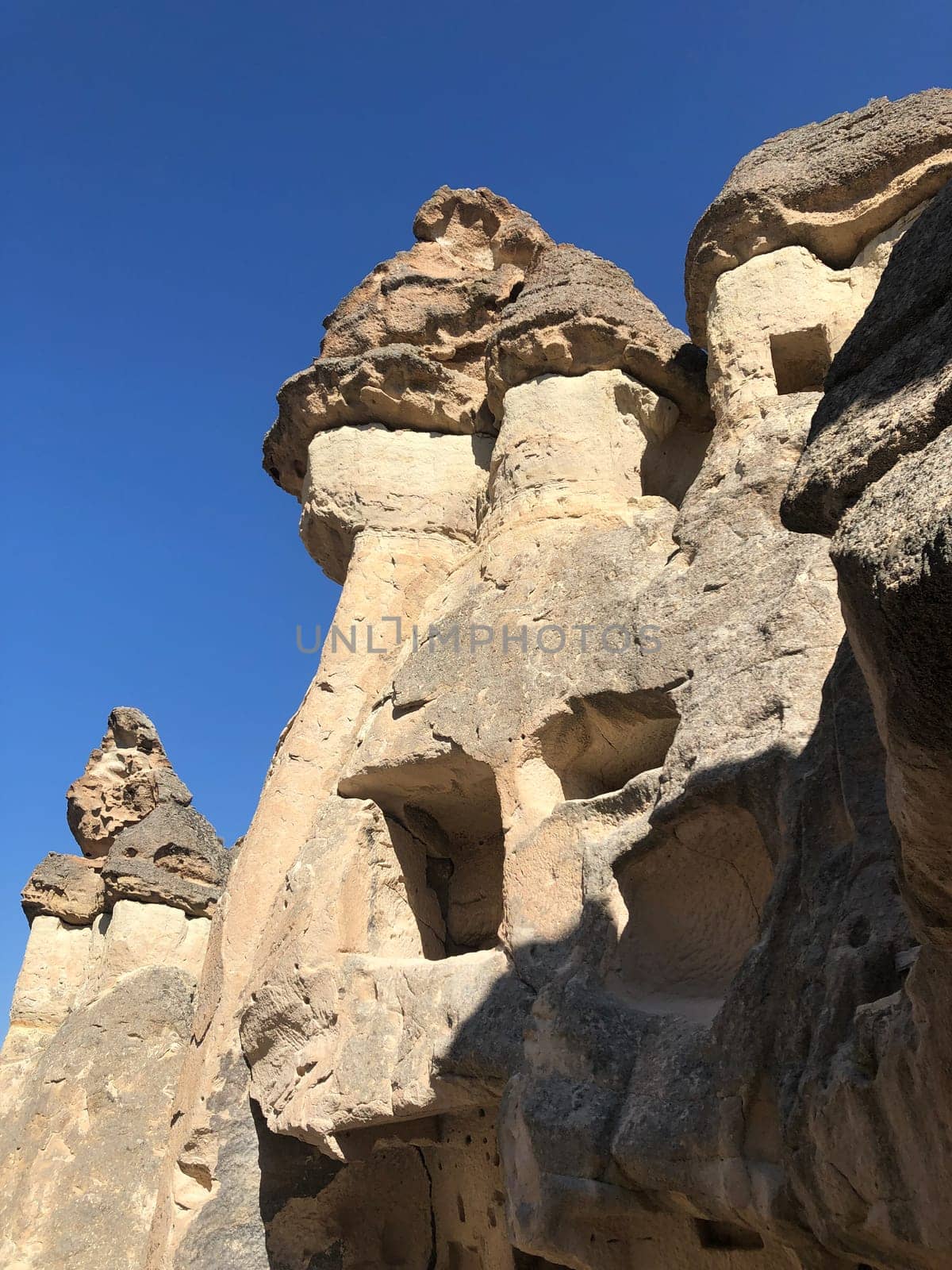 Aerial drone shot of the Fairy Chimneys over the landscape of Goreme, Cappadocia. High quality photo