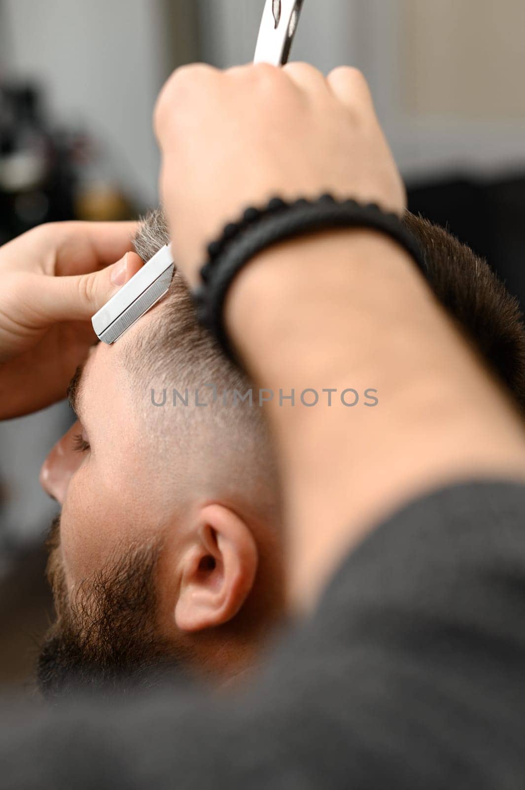 The barber makes the outline with a dangerous razor the undercut haircut by Niko_Cingaryuk