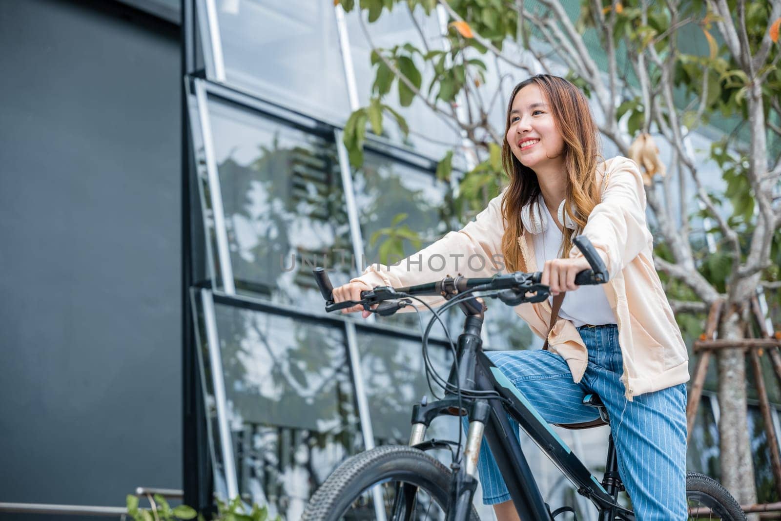 Portrait of smiling female lifestyle using bike in summer travel means of transportation by Sorapop