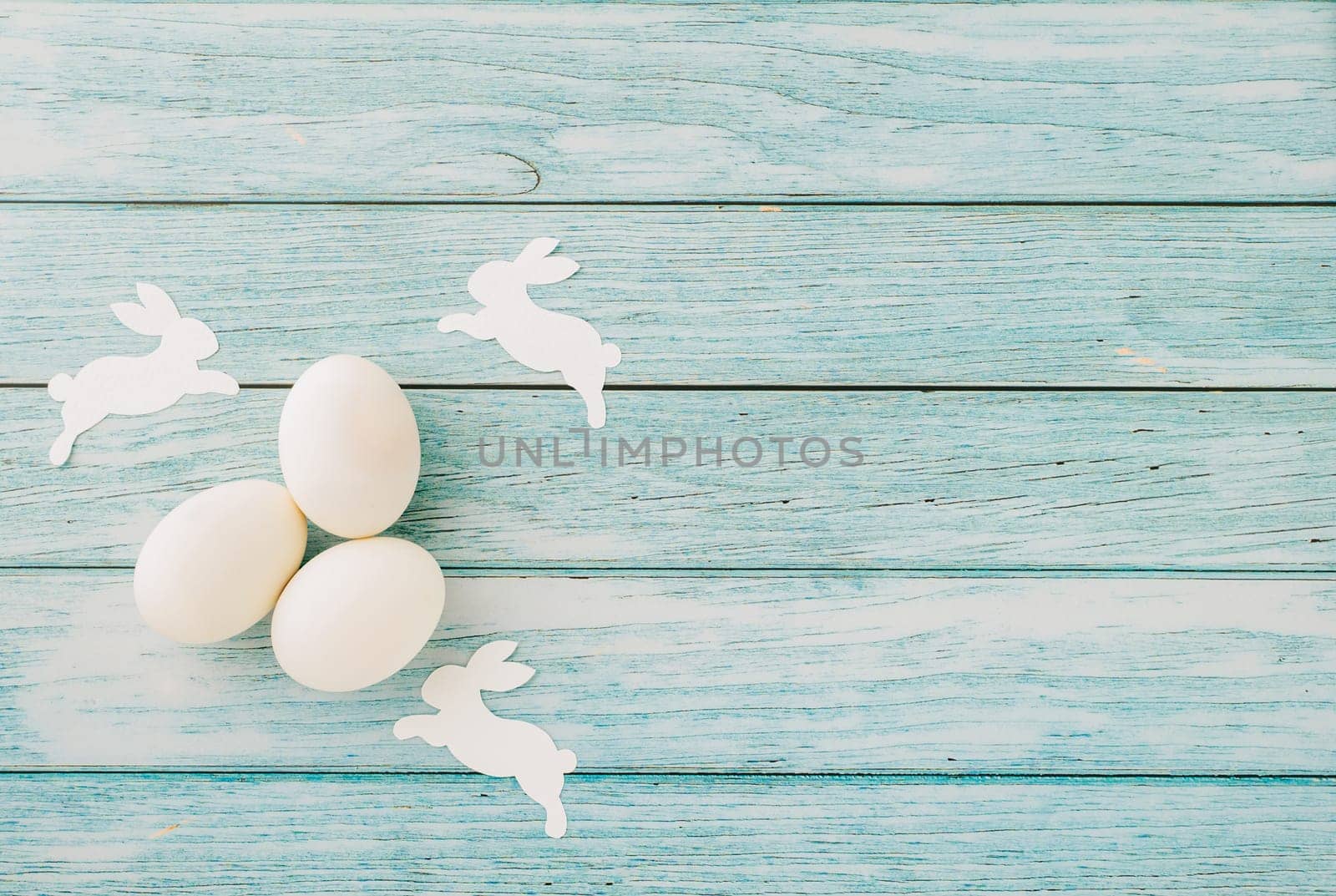 Happy Easter Day Concept. Top view flat lay of holiday banner background design white easter eggs on blue wooden background with copy space, celebration greeting card