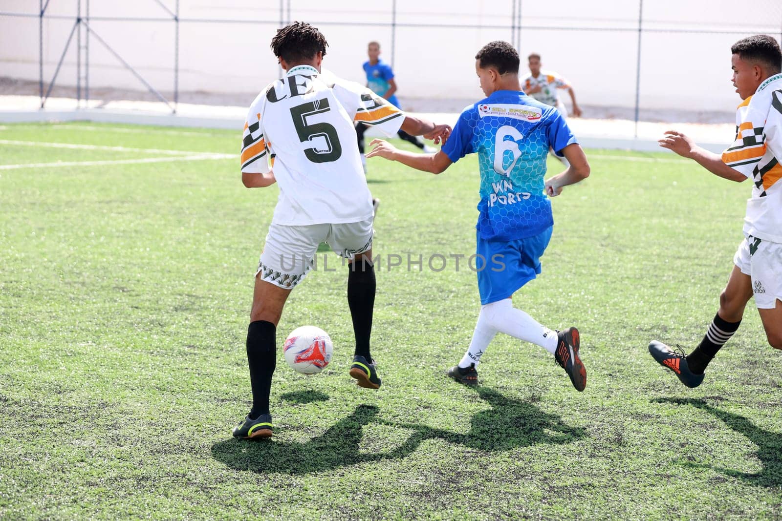 young man playing football by joasouza