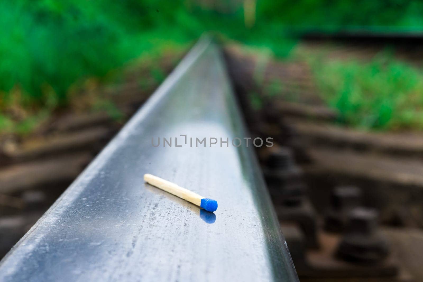 Matches on a rails railroad tracks background, fire on railways concept