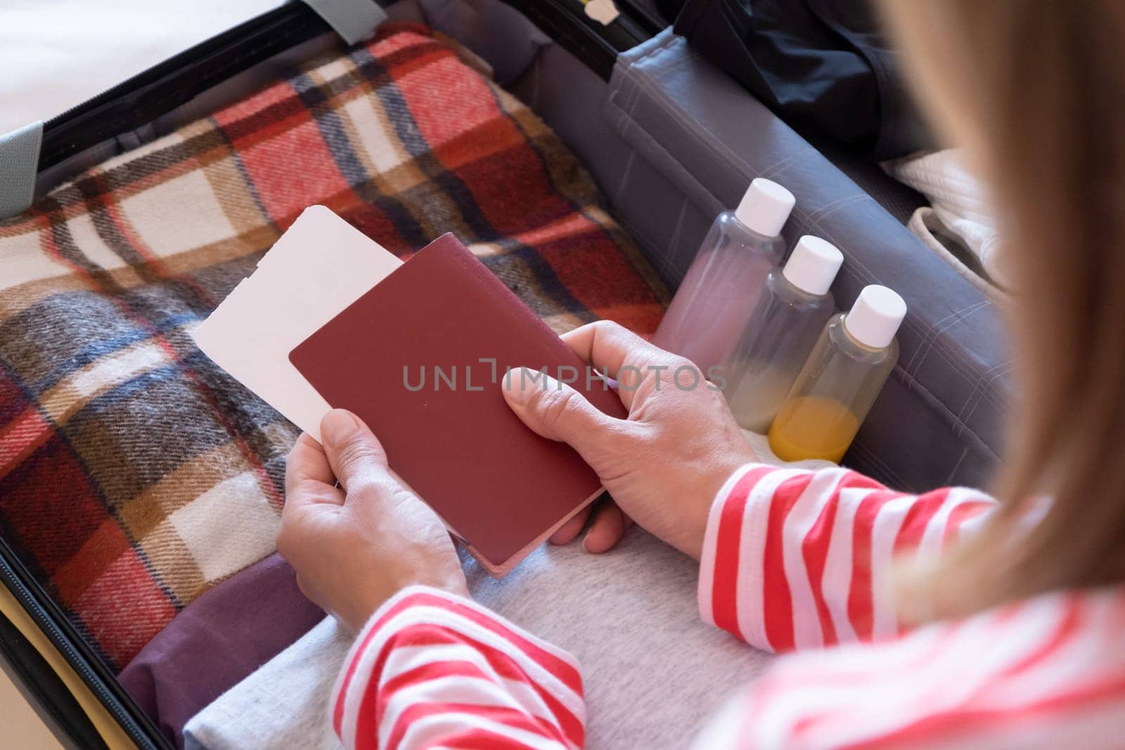 happy woman preparing for holidays, packing suitcase on bed