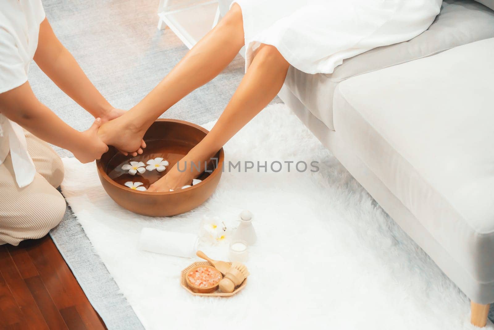 Woman indulges in blissful foot massage at luxurious spa salon. Quiescent by biancoblue
