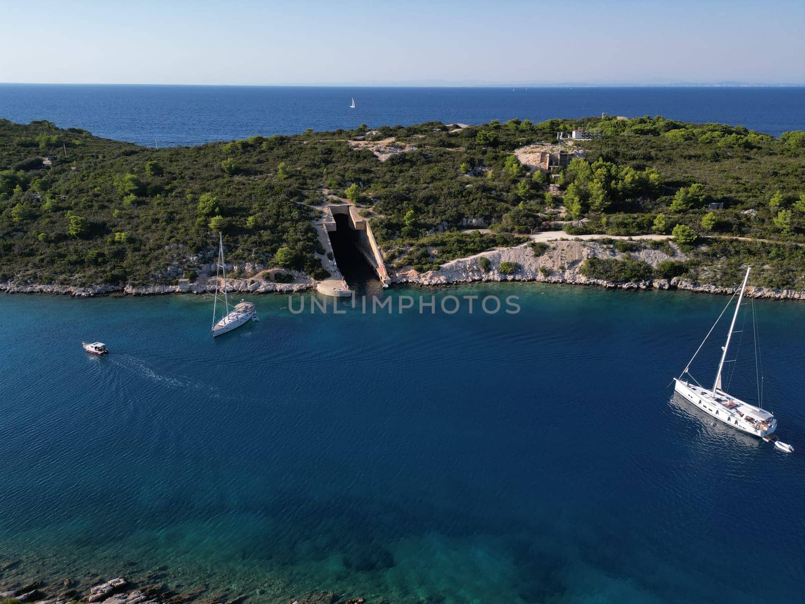 A Submarine world war Hangar in Vis Island, Italian Lissa, island of Croatia in the Adriatic Sea. It is the outermost major island of the Dalmatian archipelago panoramic aerial view landscape