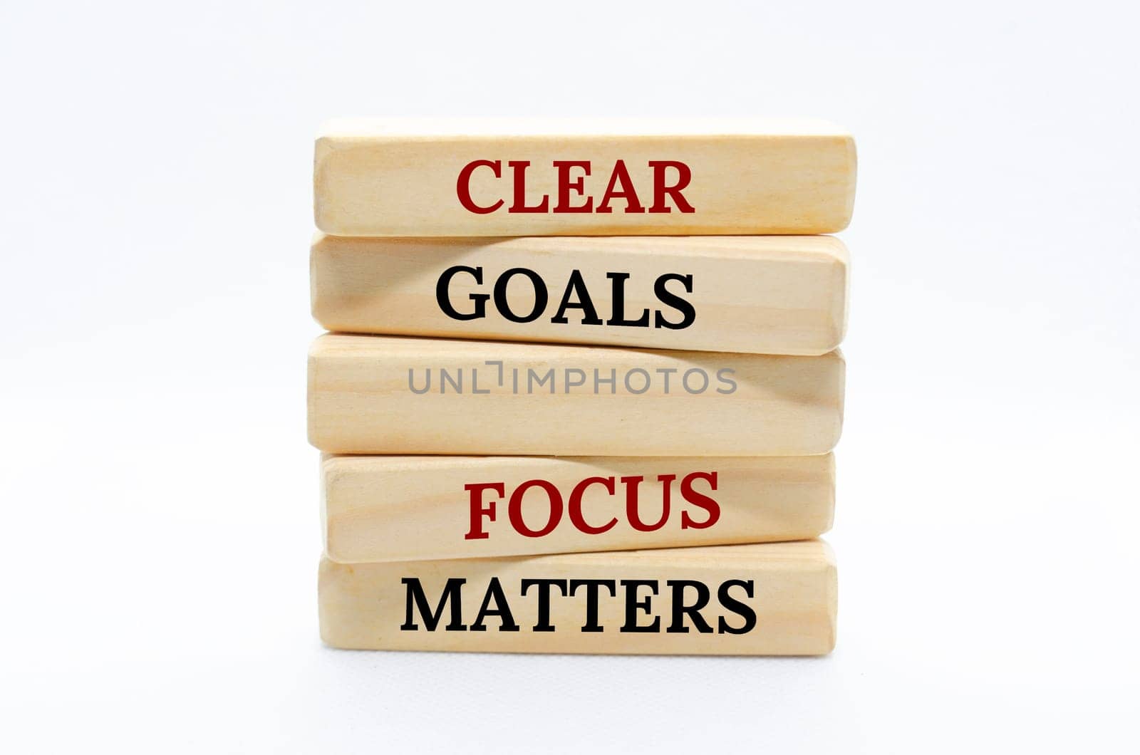 Clear goals and focus matters text on wooden blocks with white cover background.
