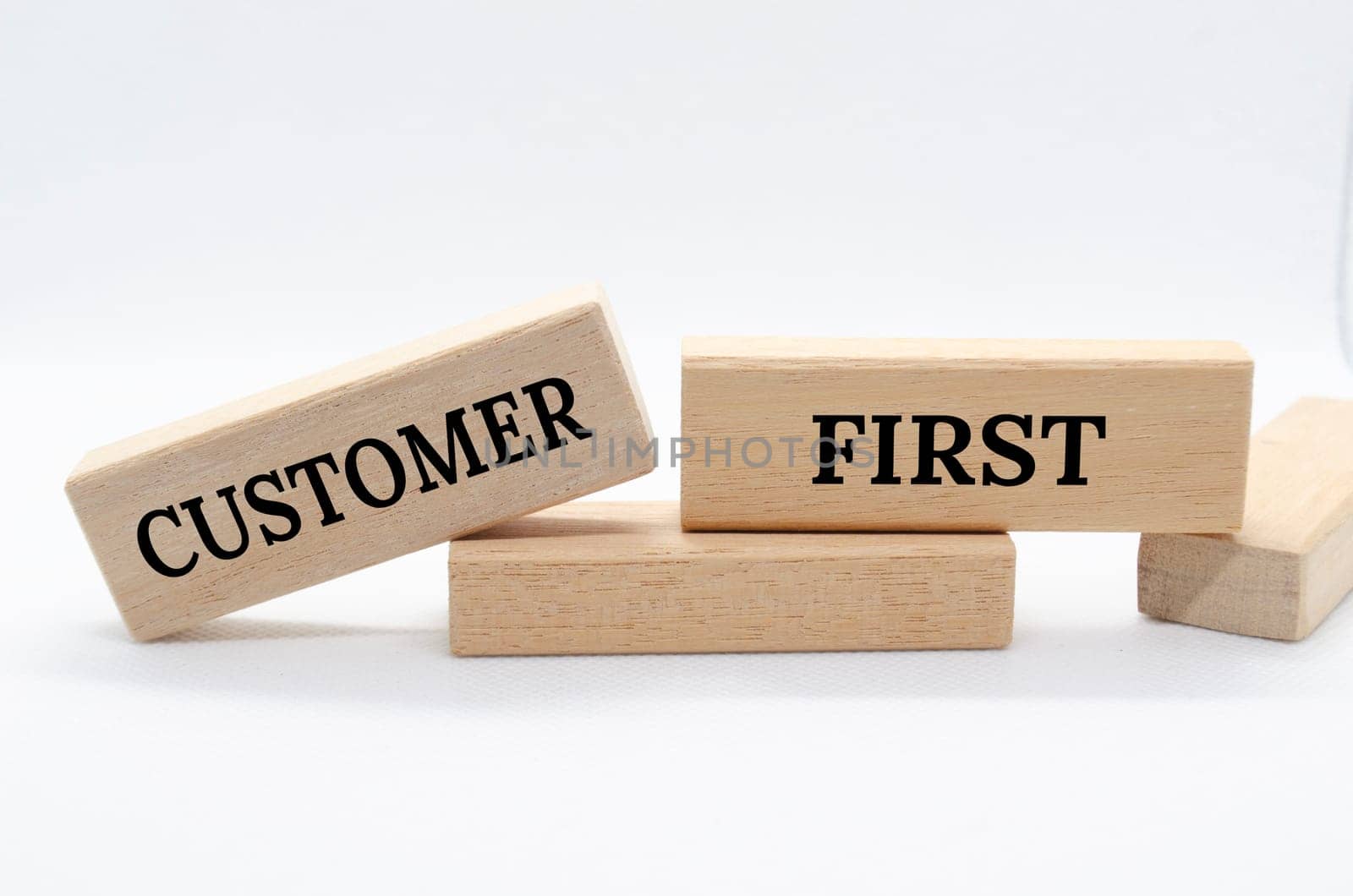 Customer first text on wooden blocks. Customer centric concept.