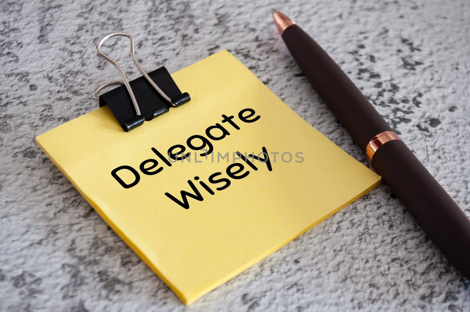 Delegate wisely text on sticky notes. Delegation of work concept.