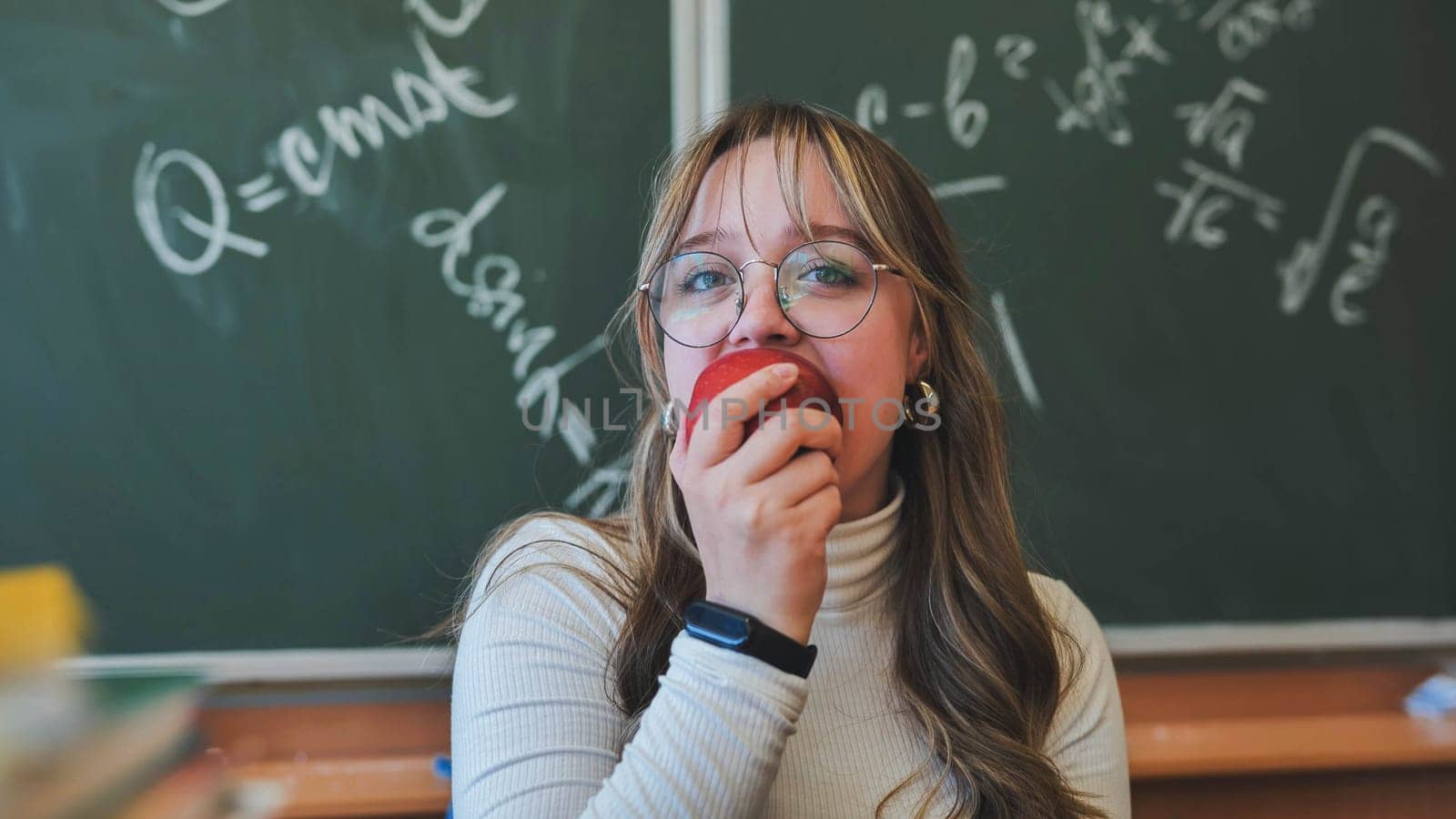 A high school girl eating an apple