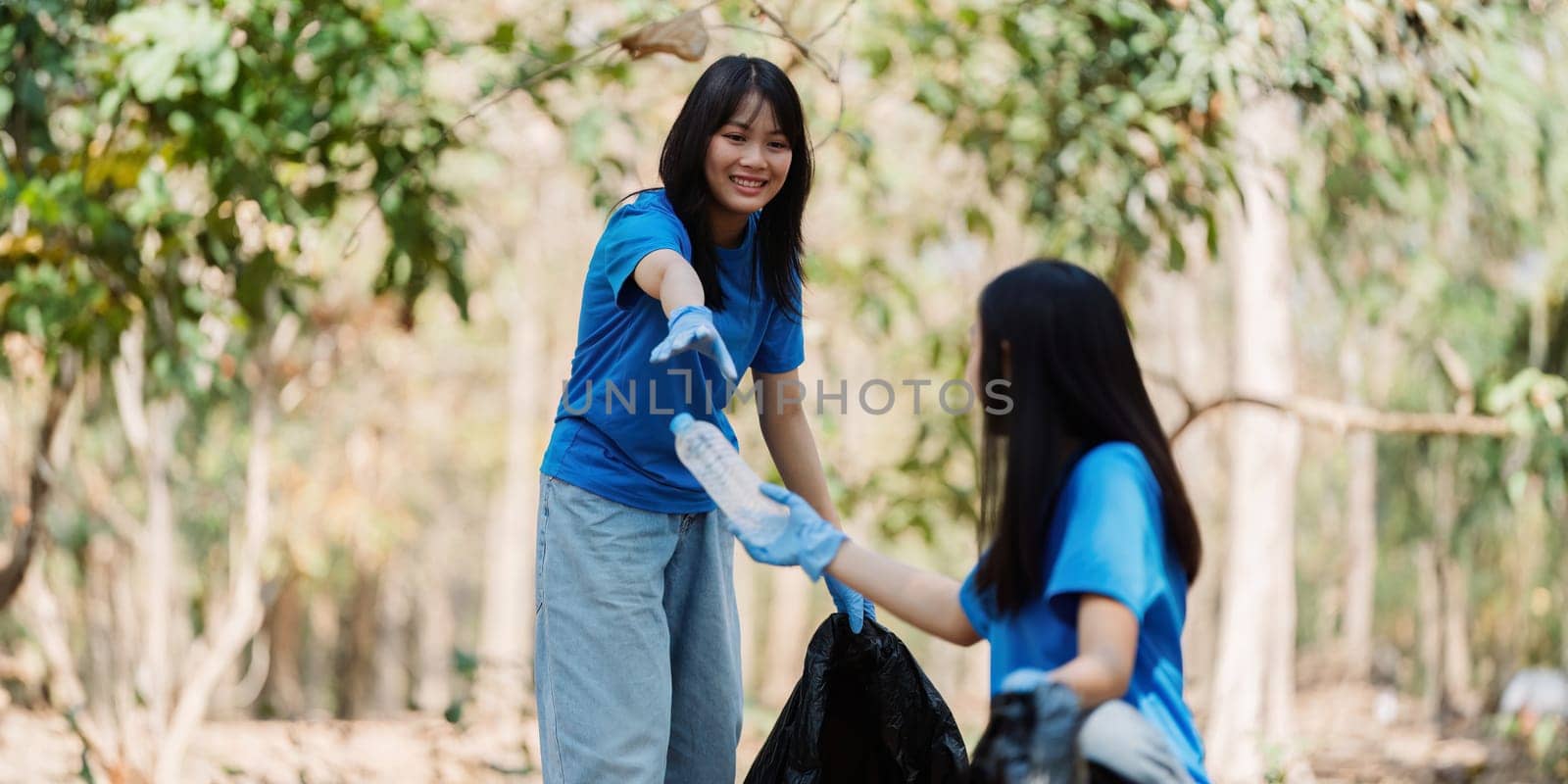 Group of volunteers, community members cleaning the nature from garbage and plastic waste to send it for recycling by itchaznong