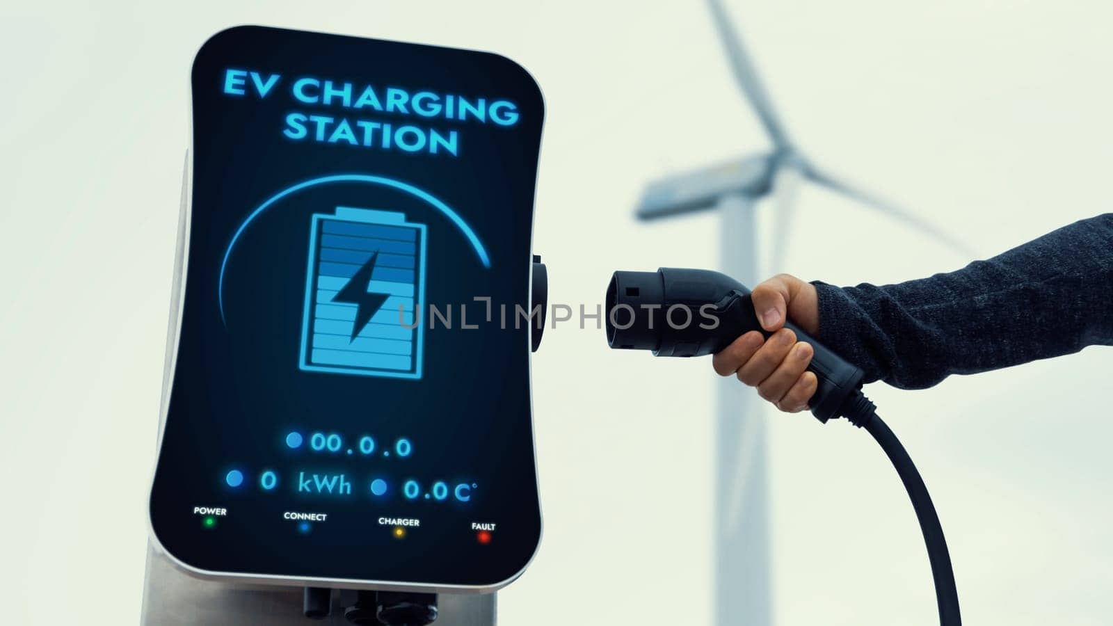 EV charger from EV car charging station at wind turbine. Persuse by biancoblue