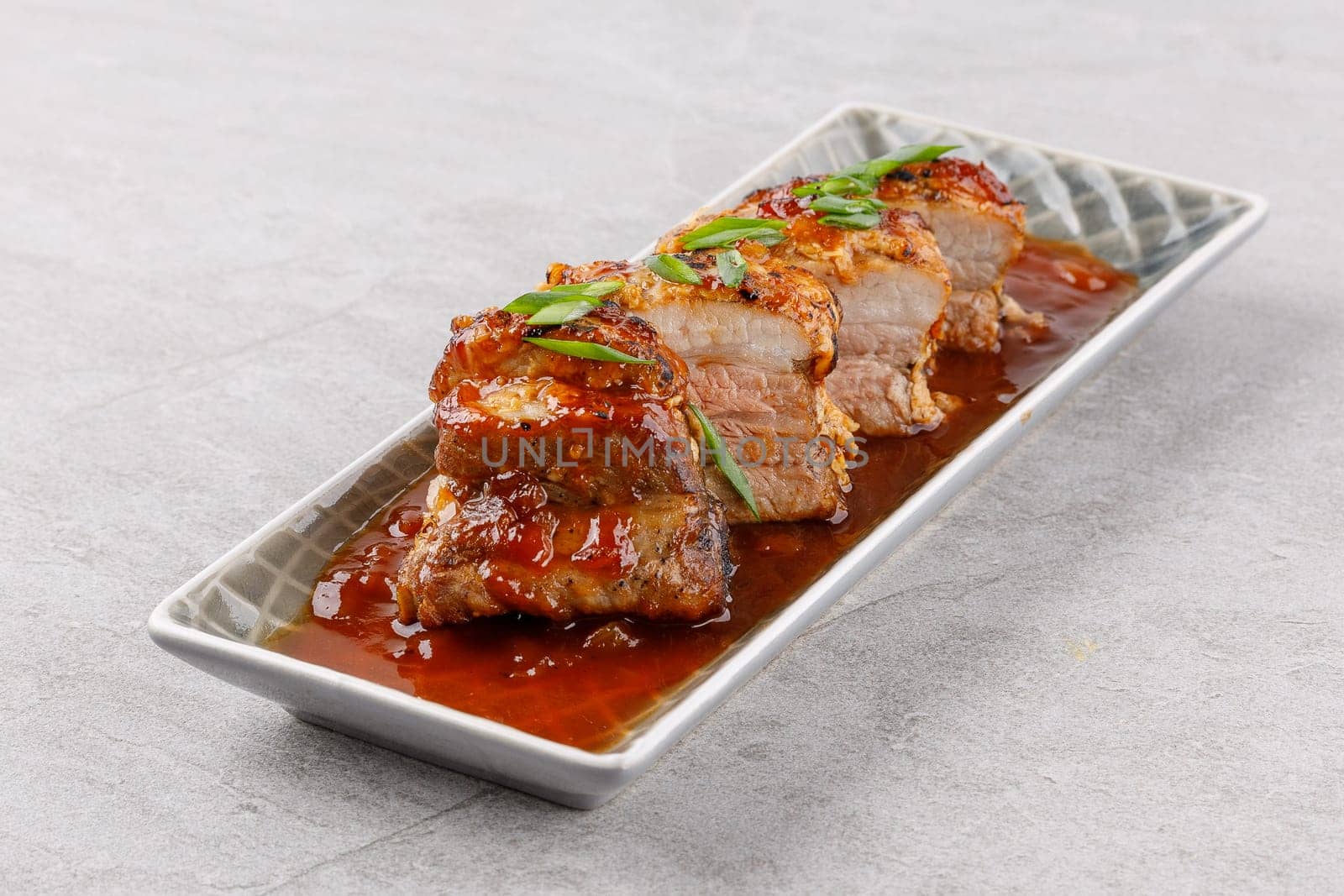 roasted appetizing pork on a stone background studio food photo 2