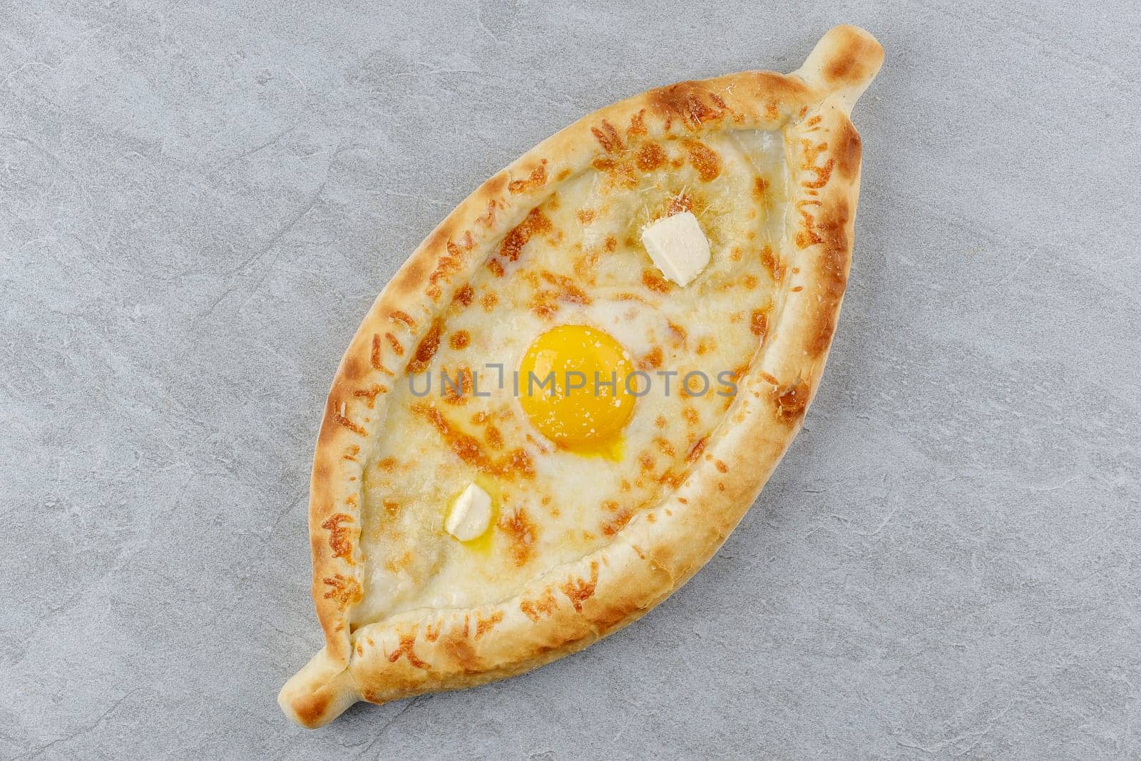khachapuri in Adjarian style on a stone background studio food photo 4