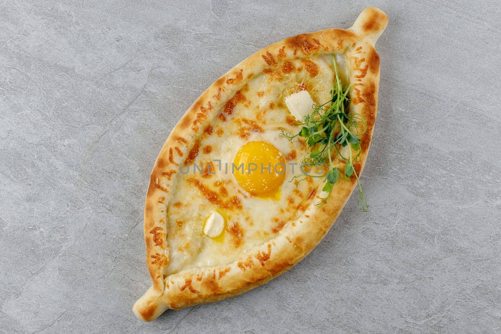 khachapuri in Adjarian style on a stone background studio food photo 2
