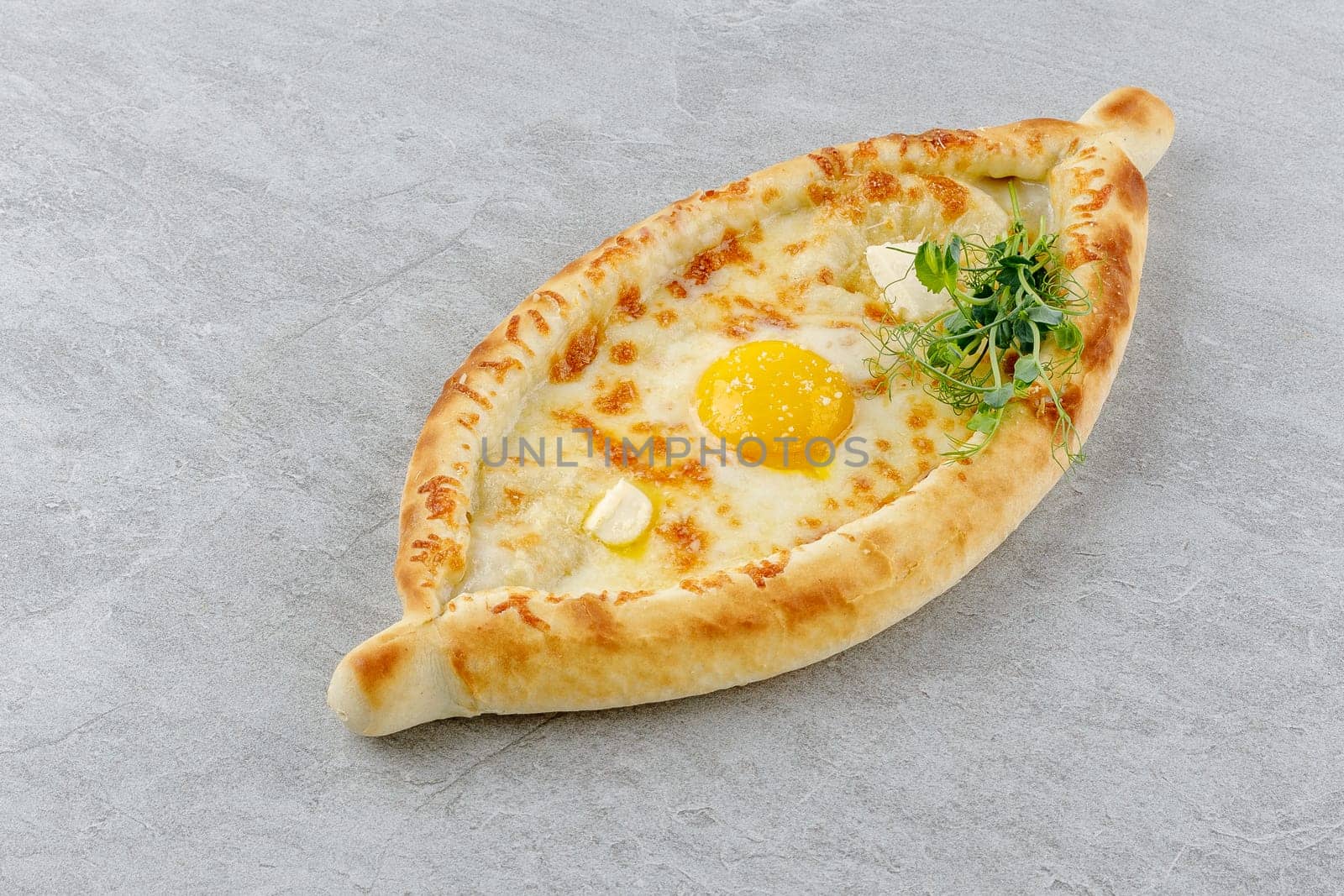 khachapuri in Adjarian style on a stone background studio food photo 1