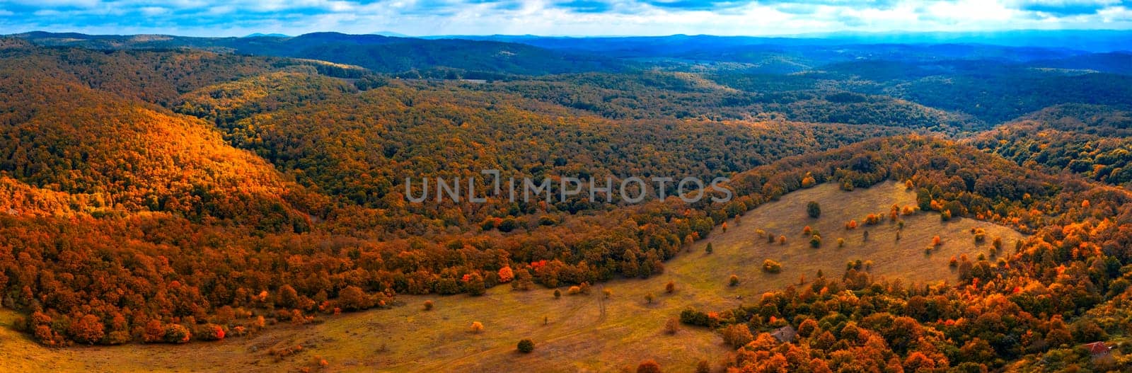 Panoramic aerial view of mountain peaks covered with autumn colors by EdVal