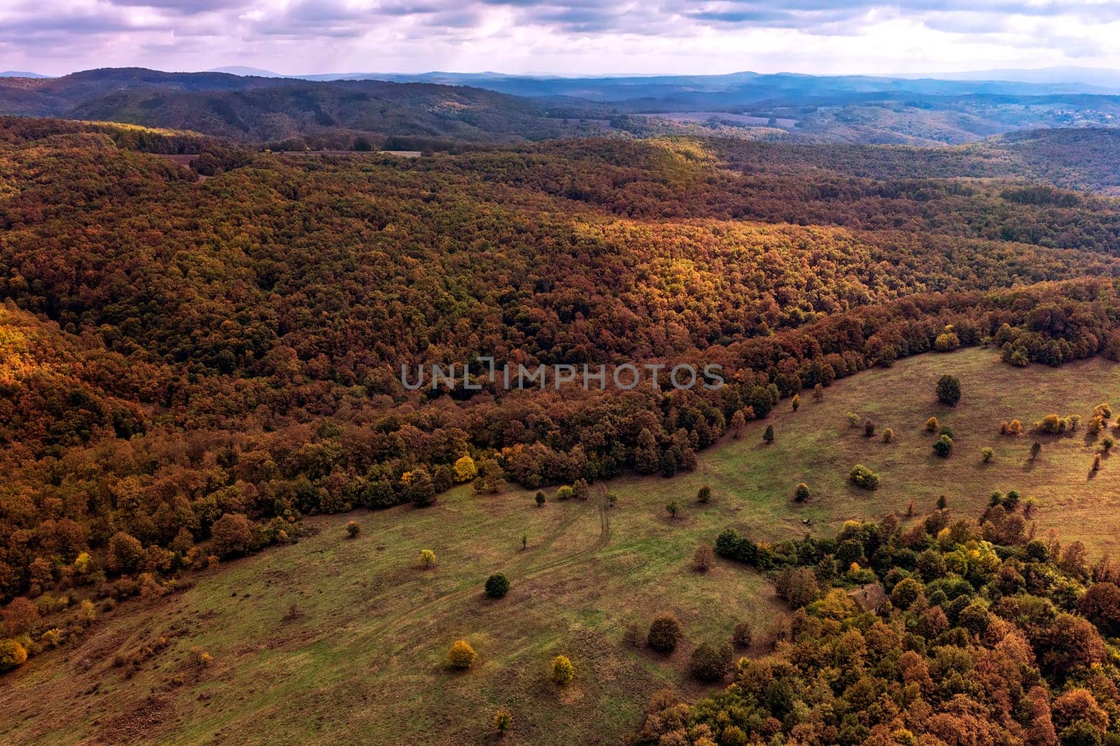 aerial view of mountain and valley  covered with autumn colors