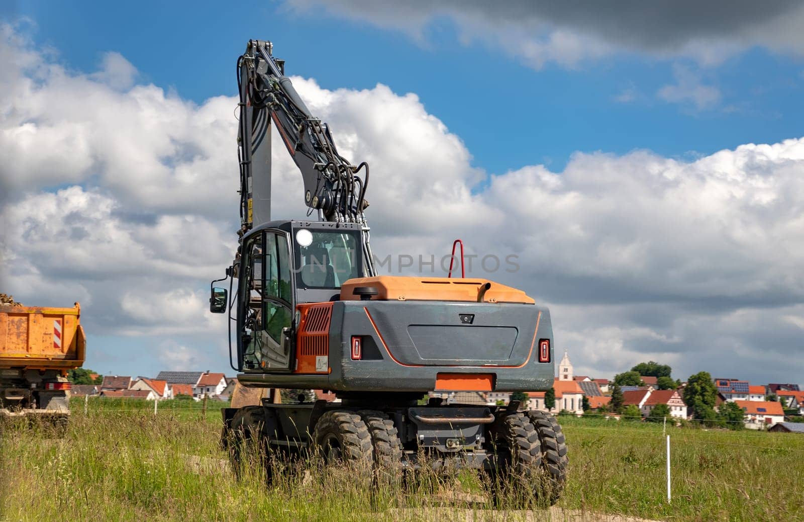 Excavator with a shovel at the road. Horizontal view