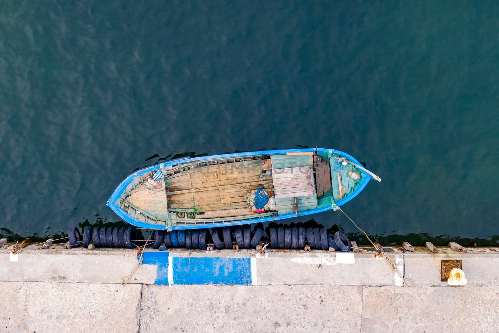 Aerial top view by Drone of the moored small fishing boat at the quay.  by EdVal