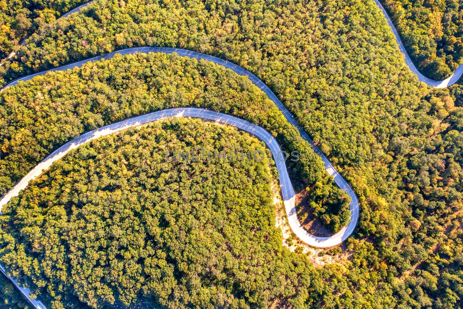 Aerial view from drone of curves of mountain road. Transportation and infrastructure concept