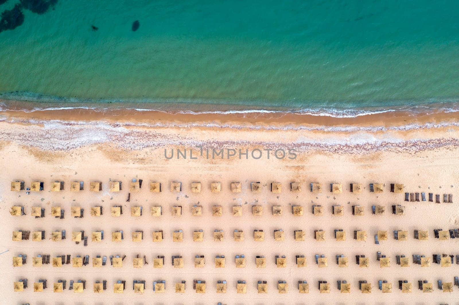 Aerial view of a fantastic beach with umbrellas, and a calm sea. by EdVal