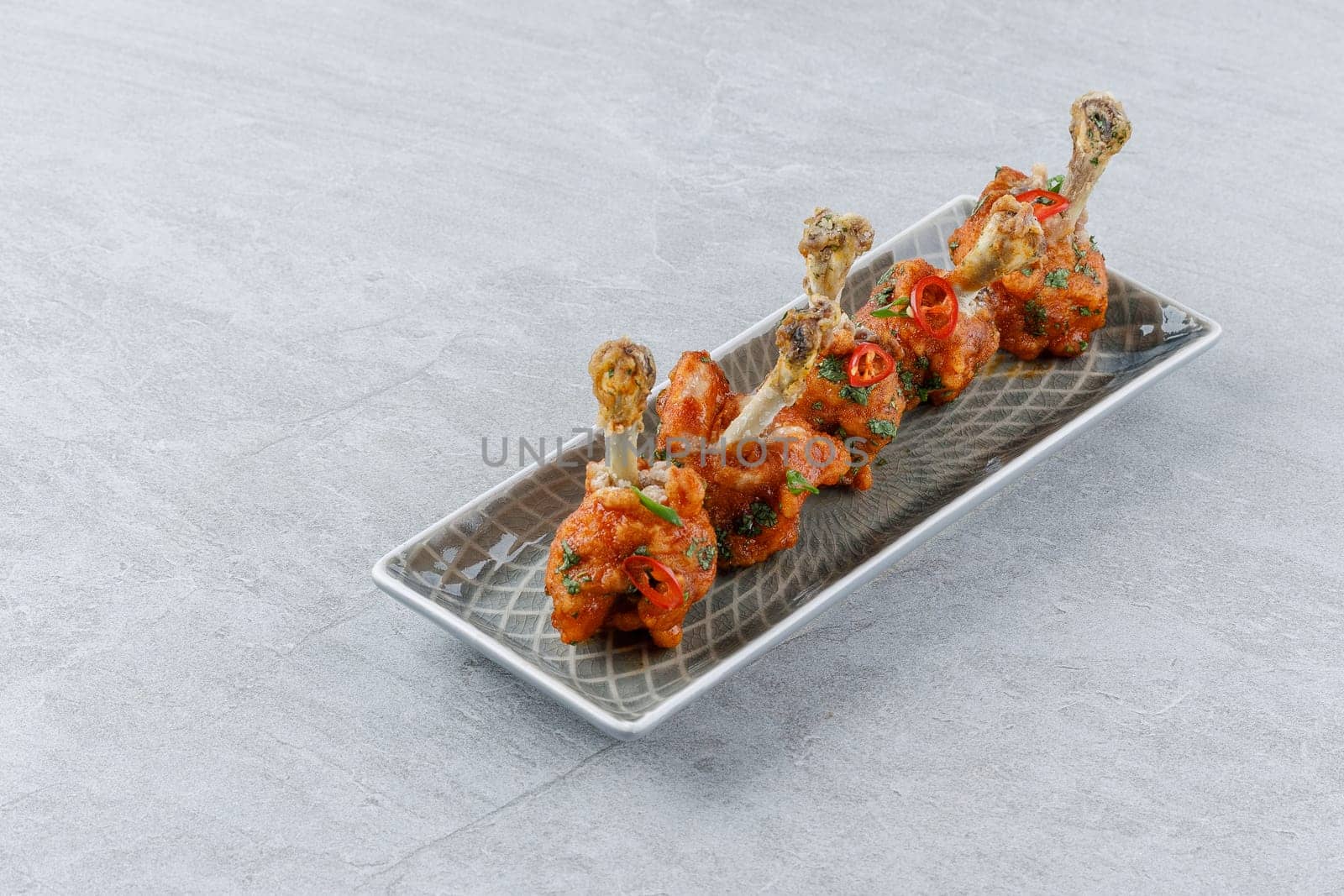 chicken wings baked on a stone background studio food photo 2