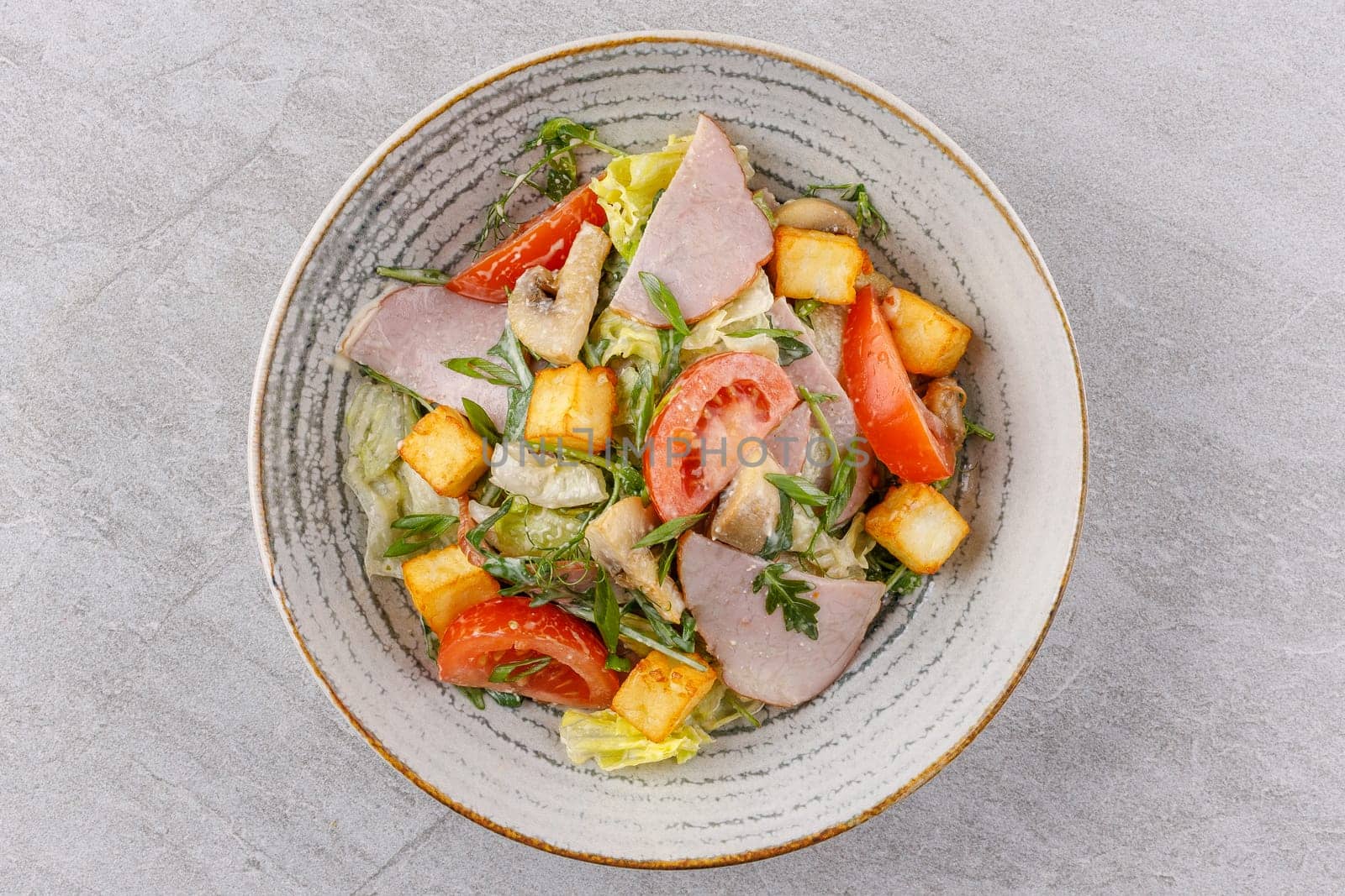 salad with ham and halloumi cheese on a stone background studio food photo 10