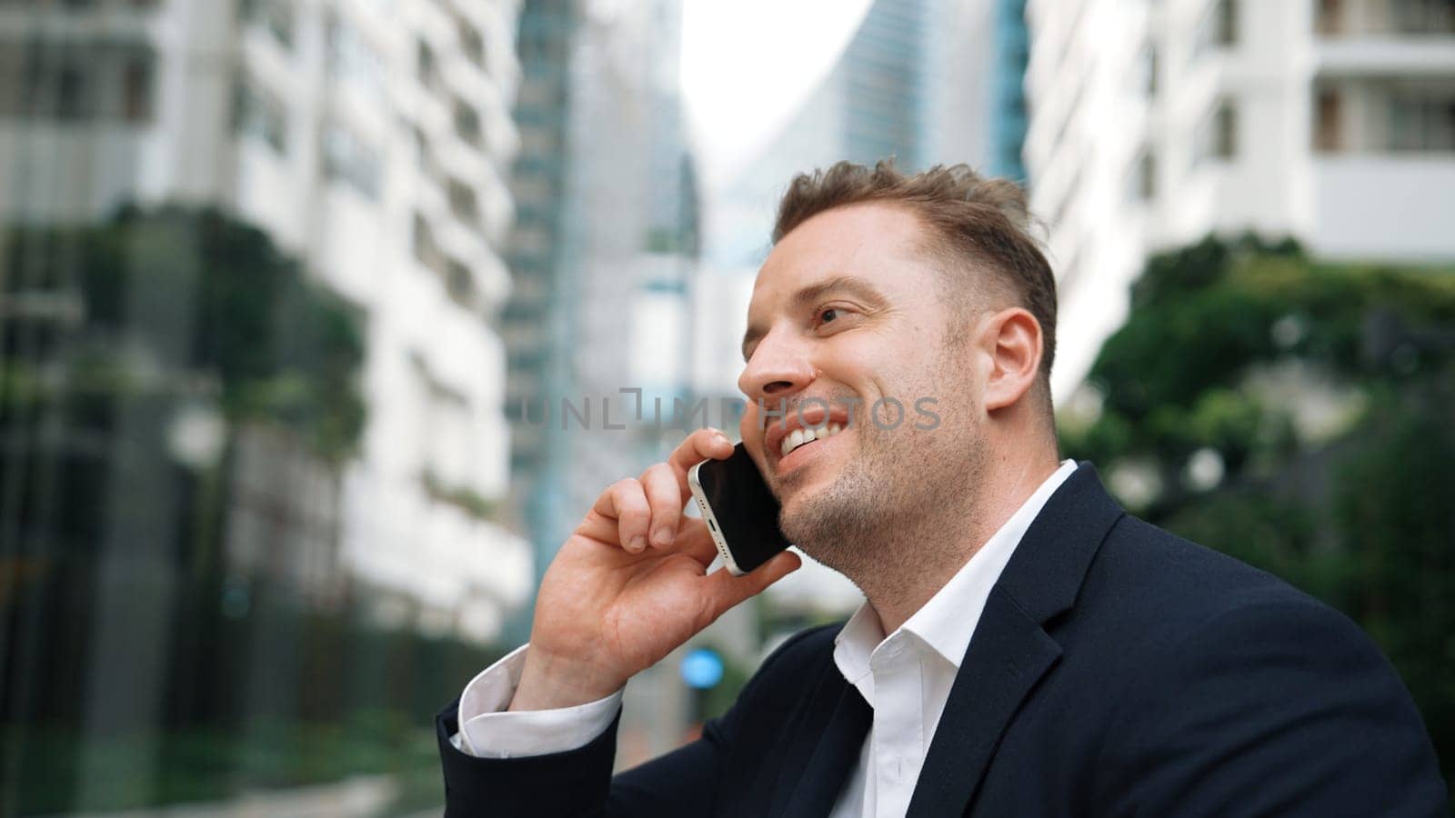 Businessman talking to manager about financial strategy by using phone with blurred background. Project manager calling investor and present marketing idea with blurred background. Lifestyle. Urbane.