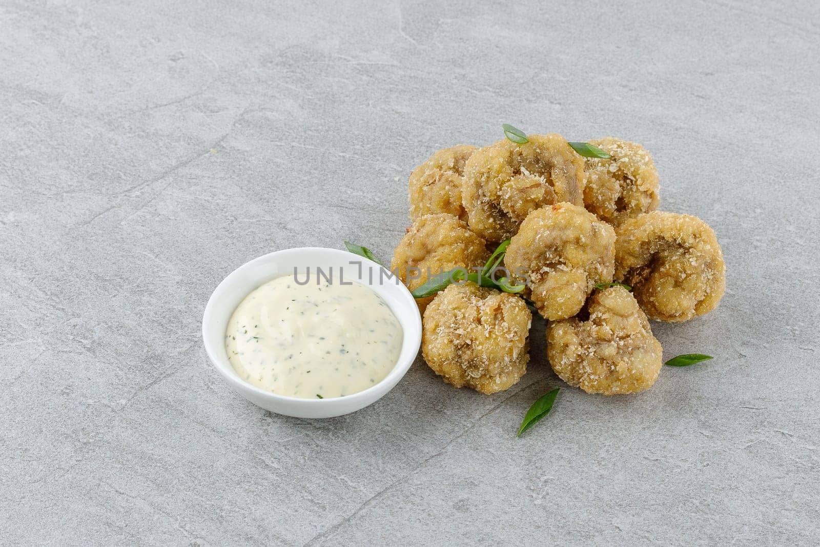 mushrooms in batter on a stone background studio food photo 2