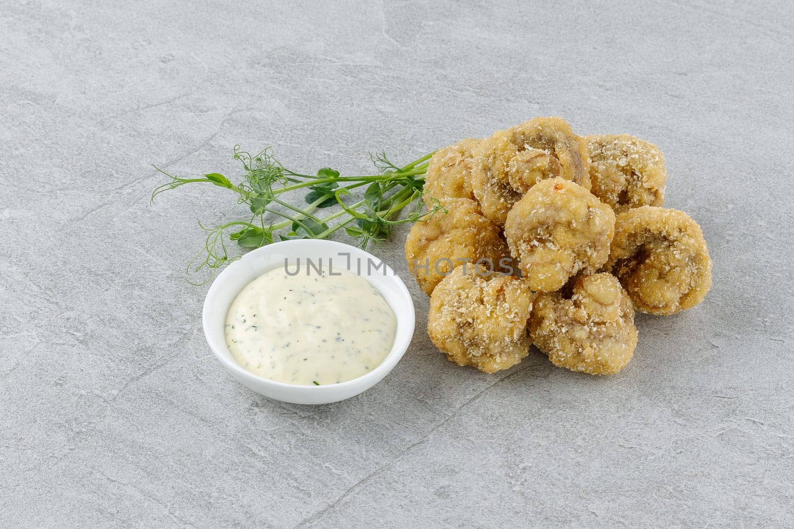 mushrooms in batter on a stone background studio food photo