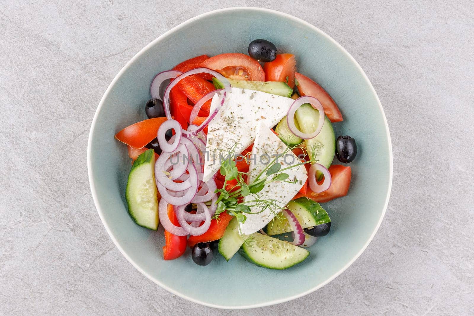 Greek salad on a stone background studio food photo 4