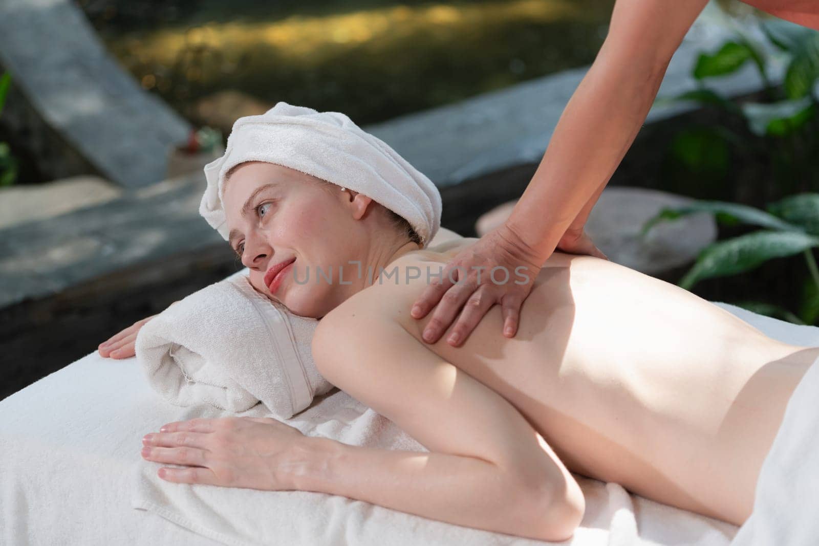 Beautiful young woman received a back massage on a spa bed. Tranquility. by biancoblue