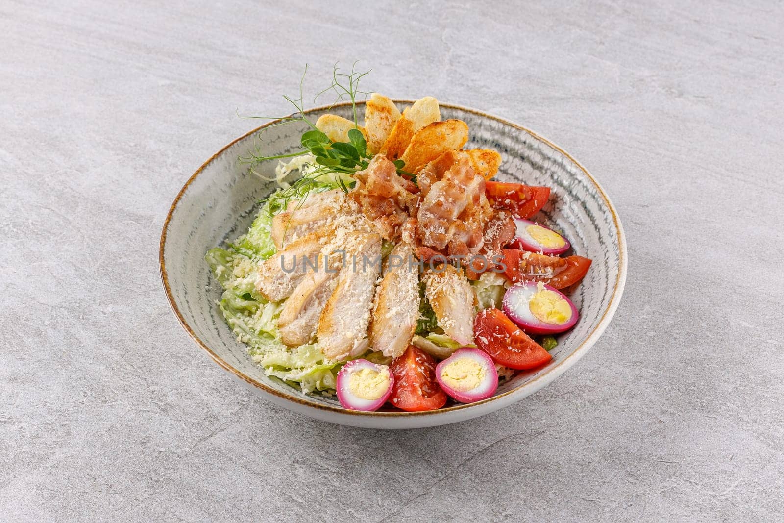 Caesar salad with chicken and bacon on a stone background studio food photo 7