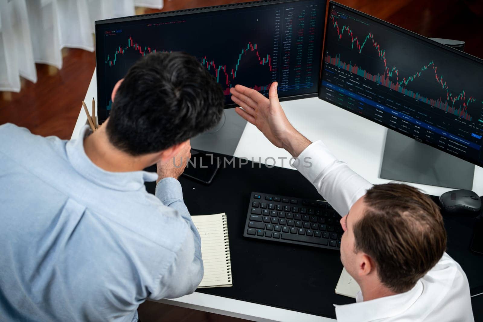 Business professional brokers discussing stock market on pc screen in real time, analyzing dynamic exchange rate database graph or interesting unit investment for trading in valued growth. Sellable.