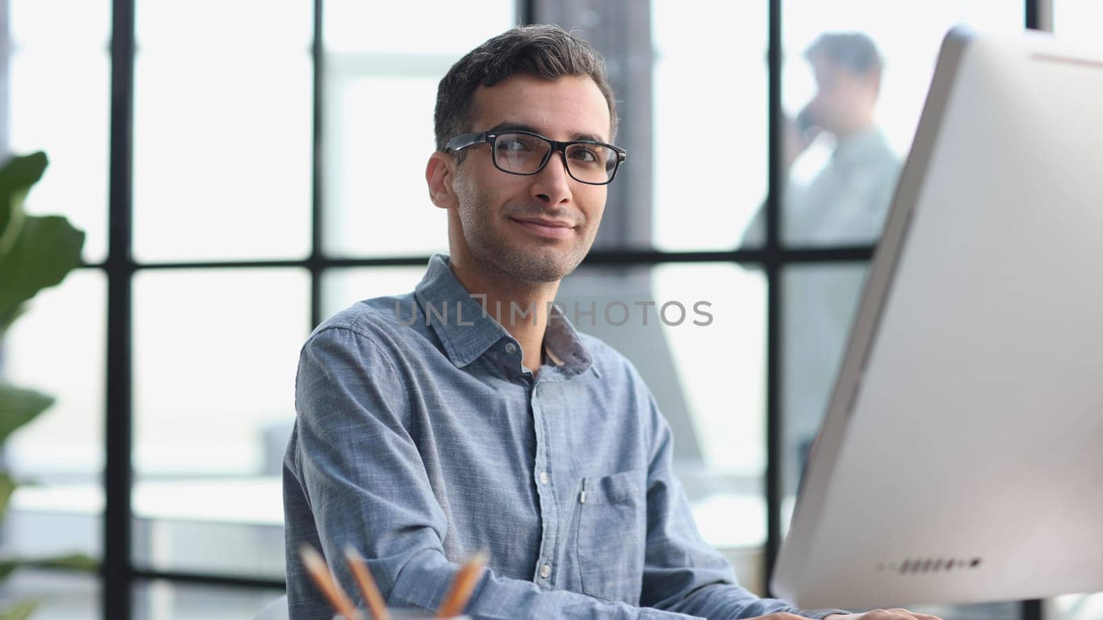 Handsome businessman working with laptop in office by Prosto